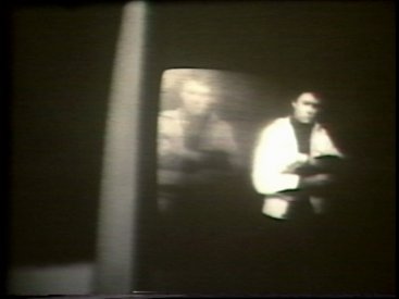 Still from Sequence 7 of Idea Demonstrations. Peter Kennedy moves in and out of his after image on the video screen.